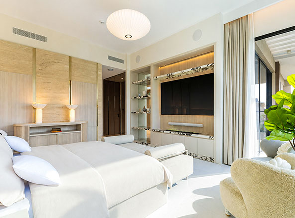 tilal al ghaf bedroom with a television wall